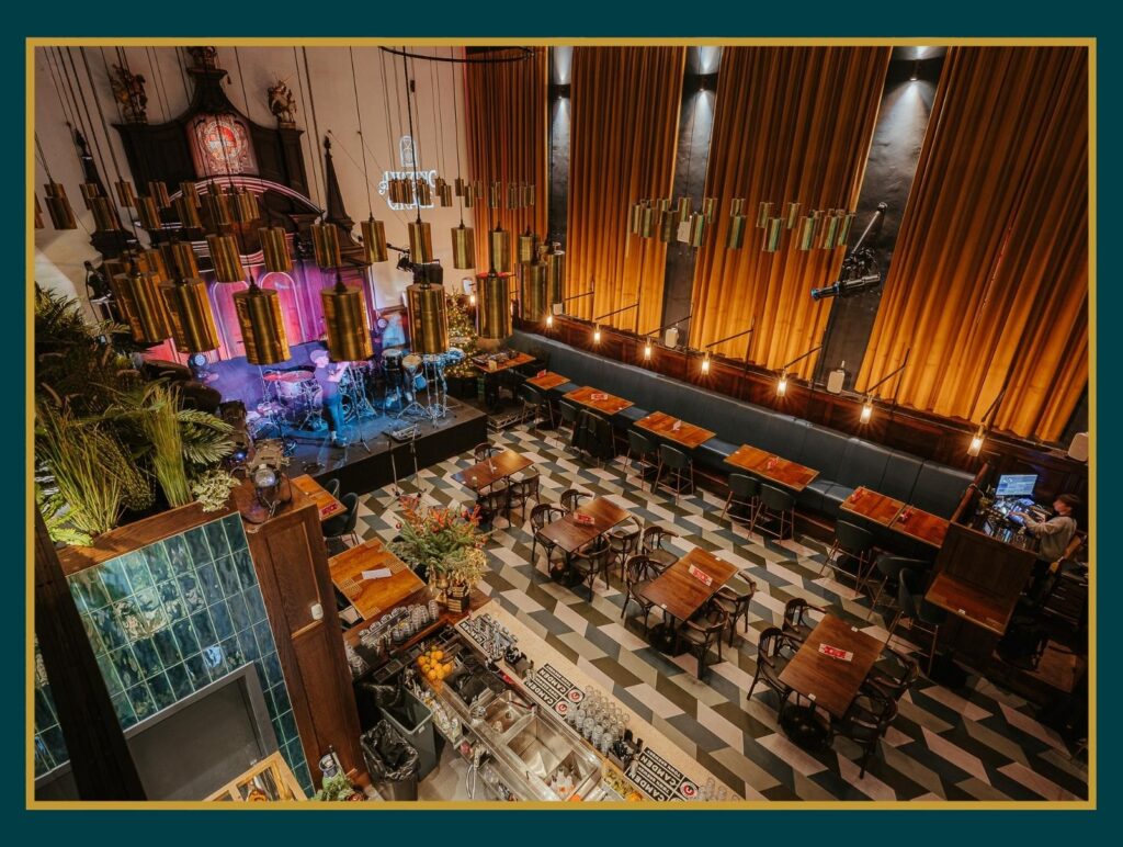 Interior of Amazing Grace London restaurant featuring a stage and a bar, creating a vibrant atmosphere for guests.