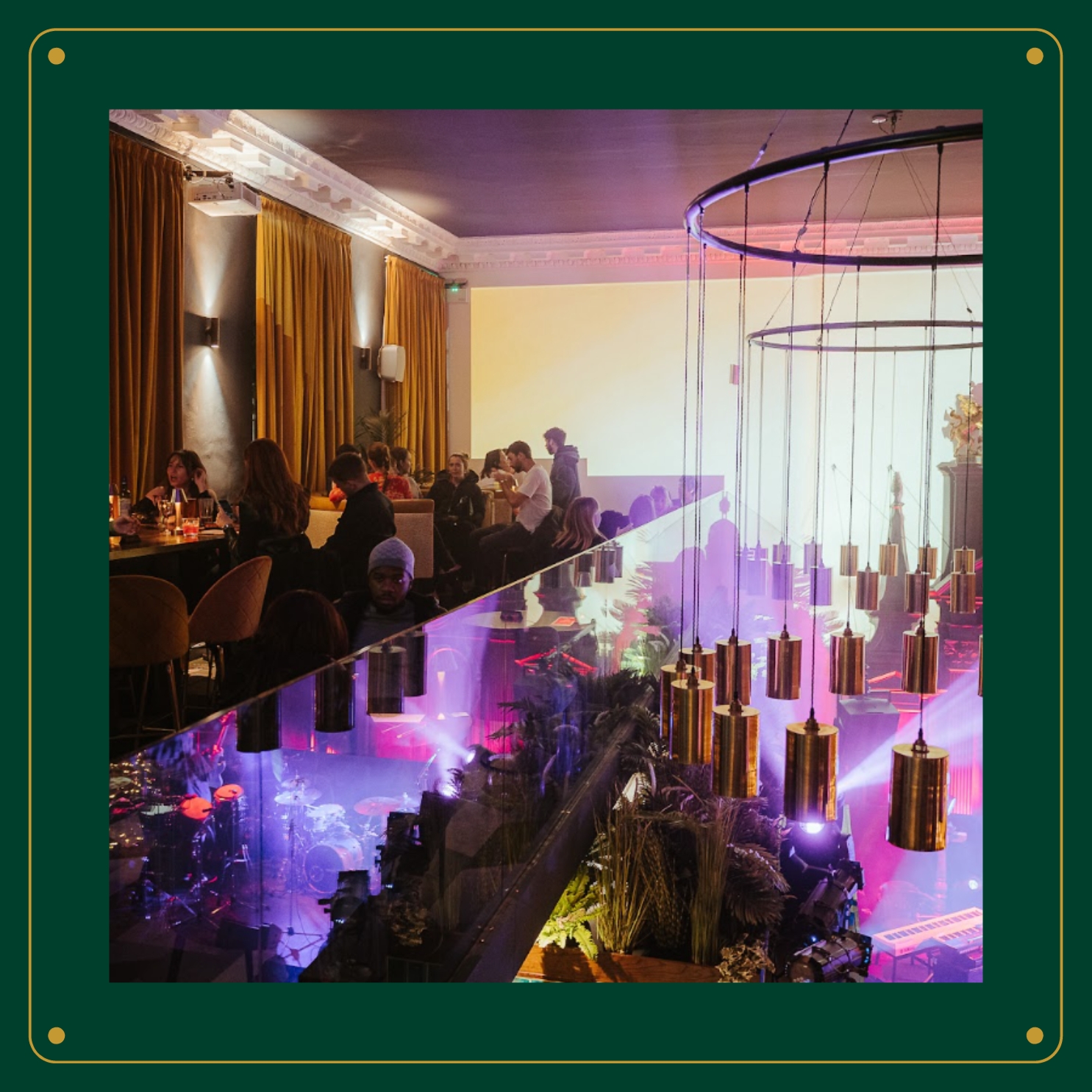 A stylish restaurant in Amazing Grace London featuring a large chandelier above an elegantly set table.