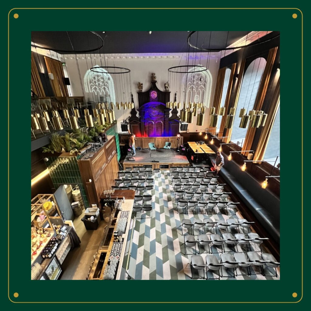 A spacious room filled with tables and chairs, showcasing the Amazing Grace London venue.
