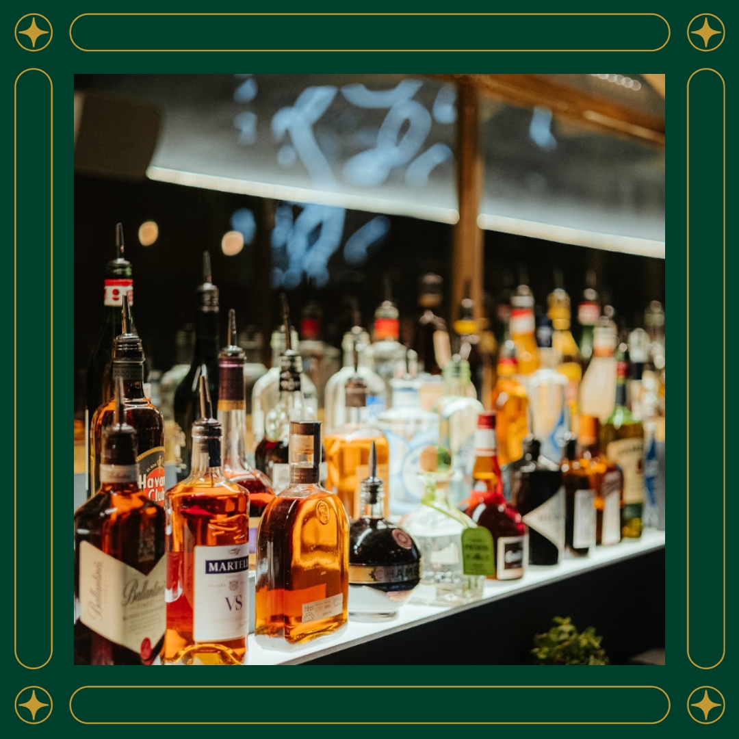 A vibrant bar at Amazing Grace London showcasing a wide array of colorful alcohol bottles on display.