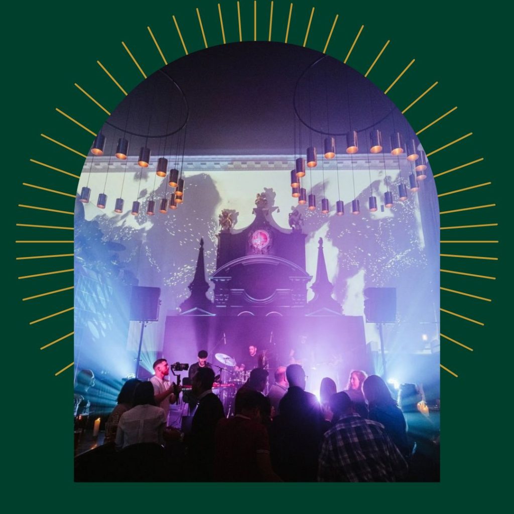 Live music performance at Amazing Grace London, showing a lively crowd gathered around a stage