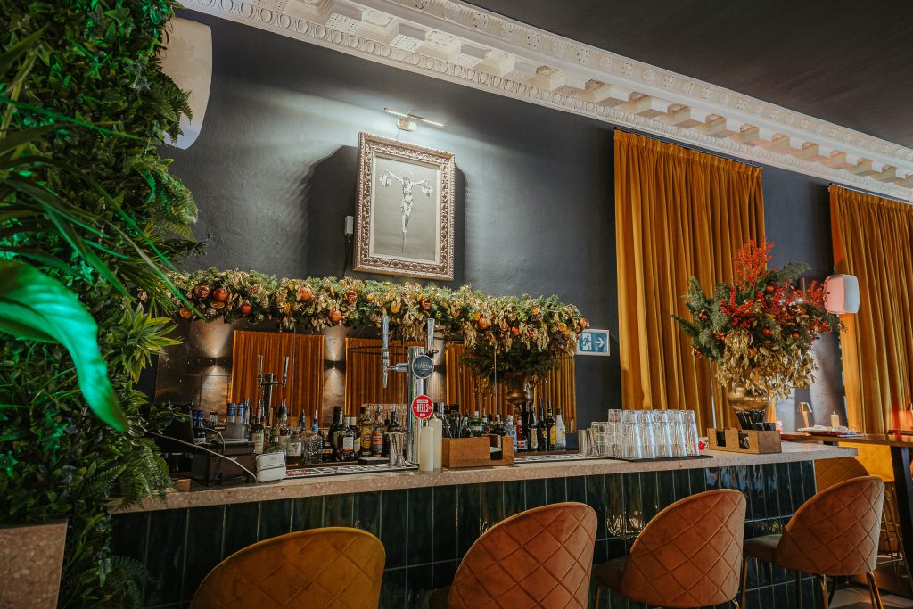 The hotel bar at Amazing Grace London features vibrant plants and flowers for a refreshing atmosphere