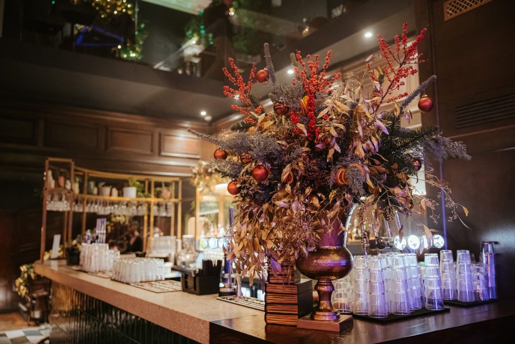 A festive floral arrangement at the bar of Amazing Grace London.